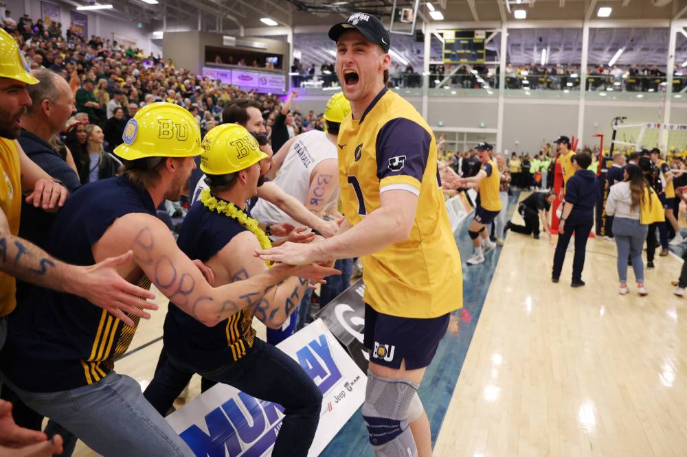 Liam Kindle celebrates with former Bobcats after capturing the national title. (Tim Smith/The Brandon Sun)